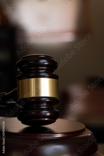 Wooden judge gavel, vertical and close-up view.