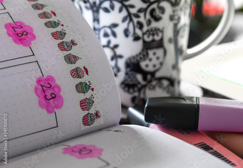 Bullet journal calendar and cup of coffee