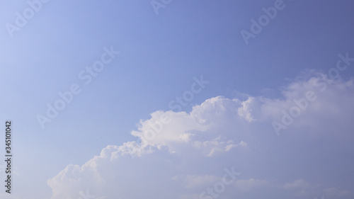 Beautiful clouds in blue sky background. Puffy and brilliant white clouds before sunset. Sky and clouds background