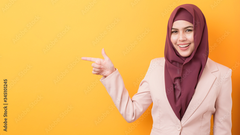 Beautiful business woman with hijab portrait on yellow background Beautiful business woman with hijab portrait on yellow background