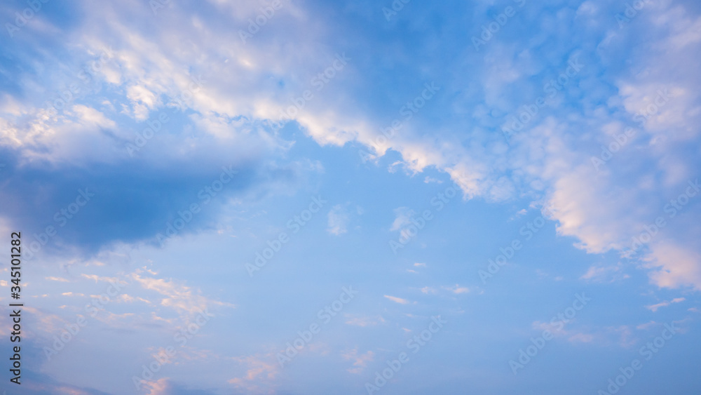 Beautiful clouds in blue sky background. Puffy and brilliant white clouds before sunset. Sky and clouds background