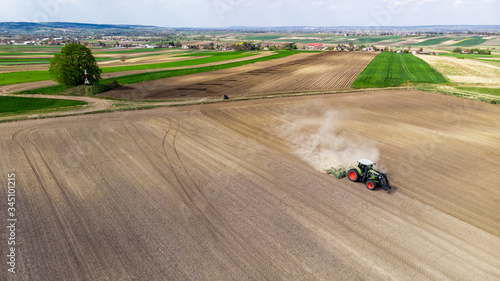 Agriculture Landscape. Tractor Working in Fields at Countryside. Aerial Drone View