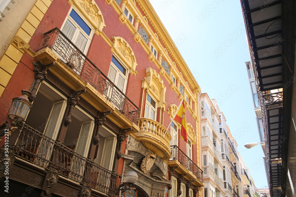 Looking up at the beutiful buildings & architecture lining La Calle Mayor, which is the heart of Cartagena.  Cartagena, Murcia, Spain.