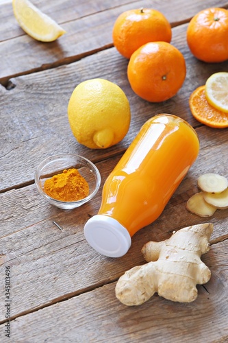 Ginger shot with citrus fruits juice, turmeric and honey. Pure vegan Immunity system booster. Copy space