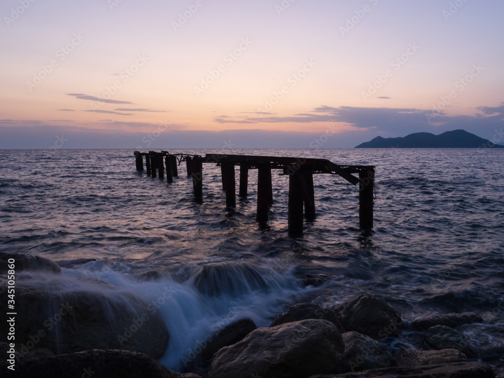 Epic sunset (dawn) on the sea. Waves are breaking on stones. Epic sunset (dawn) on the sea. Waves are breaking on stones.