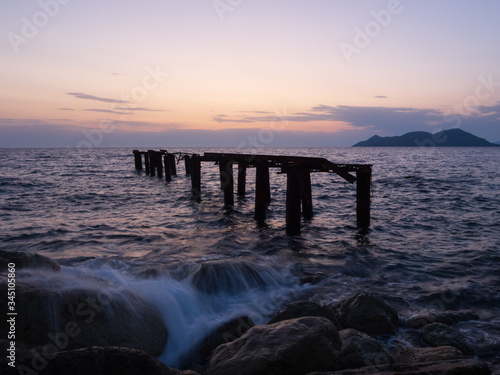 Fototapeta Naklejka Na Ścianę i Meble -  Epic sunset (dawn) on the sea. Waves are breaking on stones.