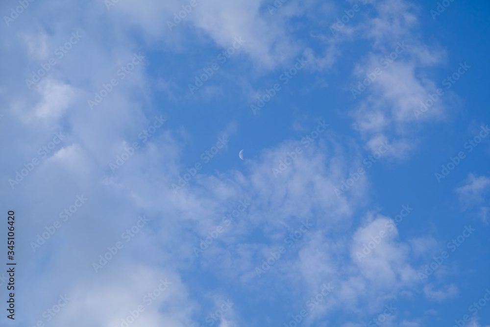 Fototapeta premium A month in the sky during the day. Clouds in the sky.