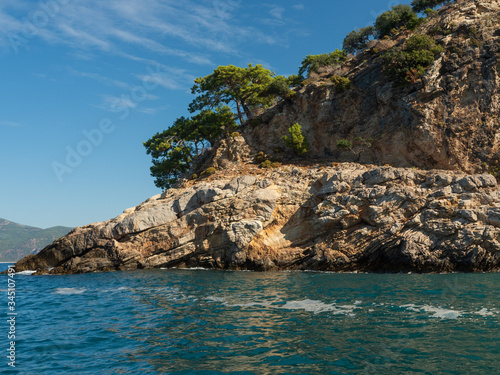 View of the coast from the sea. Amazing color of water, Bright sunny summer day.