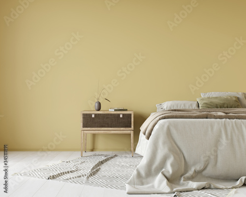 Foto Yellow bedroom with a bed covered with linen bedcover and a wooden bedside table