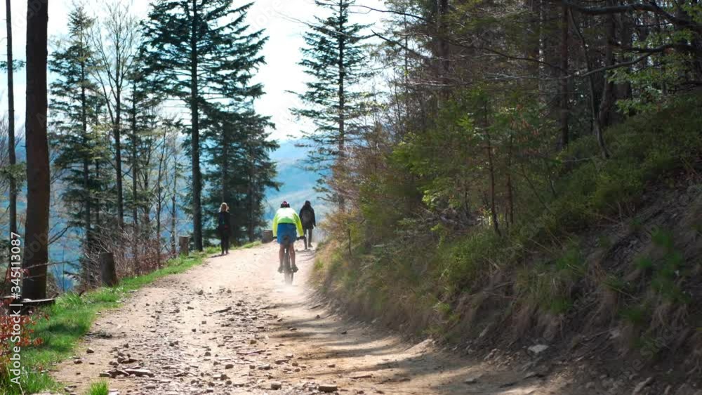 Man riding downhill at mountain path Man riding downhill at mountain path