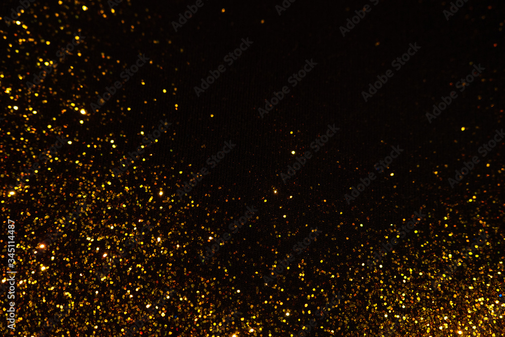 Abstract holiday background, gold Stardust on black.