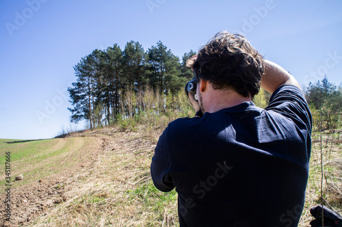 Young man takes pictures on camera. Minsk, Belarus - May 02 2020