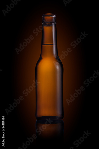 Brown small bottle full of liquid on a black background
