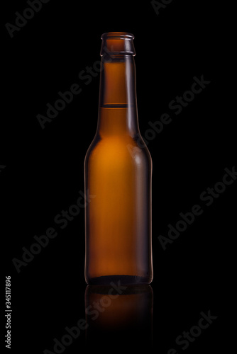 Brown small bottle full of liquid on a black background