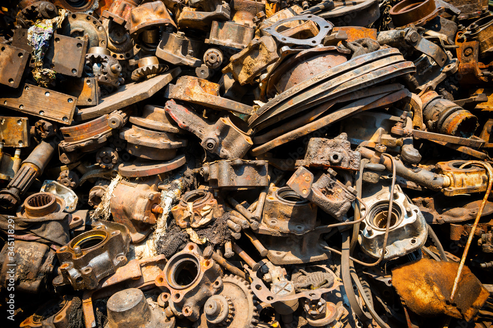 Pile of old rusty metal scrap, used machine spares and car parts can be  used as mechanic industrial background Stock Photo