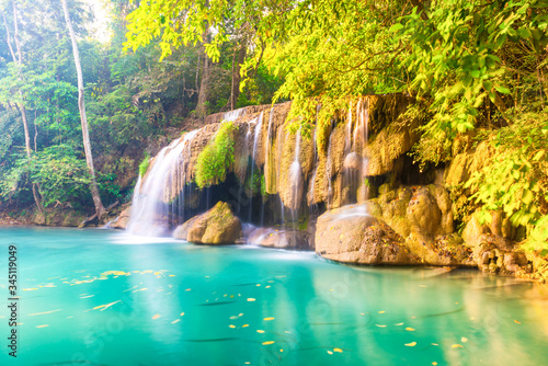 Waterfall landscape with beautiful emerald lake and green tree in wild jungle forest. Erawan National park  Thailand