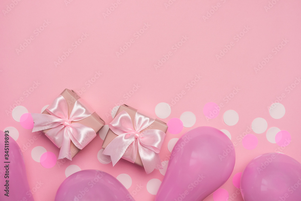 Two gift boxes with pink ribbon bow on pastel pink background with white confetti and balloons. Banner for Valentines day, Birthday or Mothers Day. Best gift for women. Top view, flat lay free space.