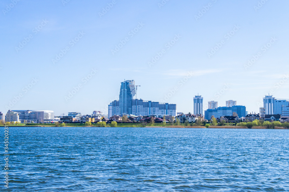 Beautiful urban lake with buildings and skyscrapers on the horizon