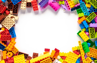 Colorful toy bricks frame with white empty space for your content