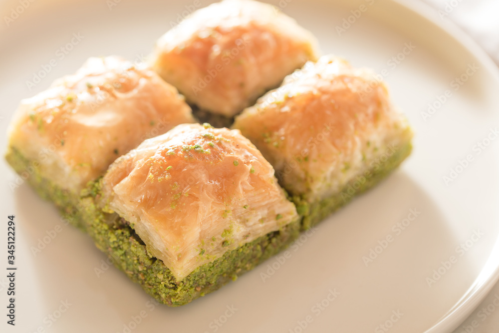 Traditional, delicious Turkish baklava on white plate Traditional, delicious Turkish baklava on white plate