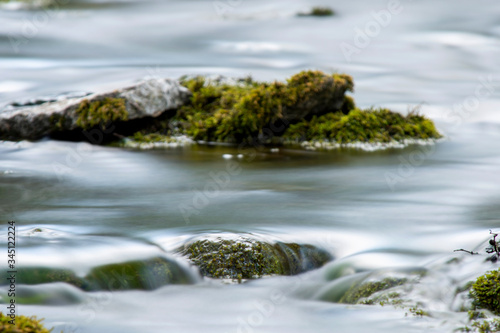 Mossy stone in an forest river , Long exposure © It4All