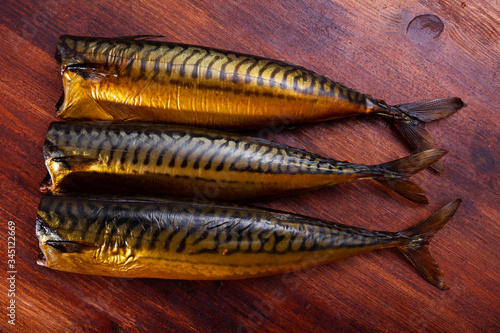 Cold-smoked mackerel without head on wooden table