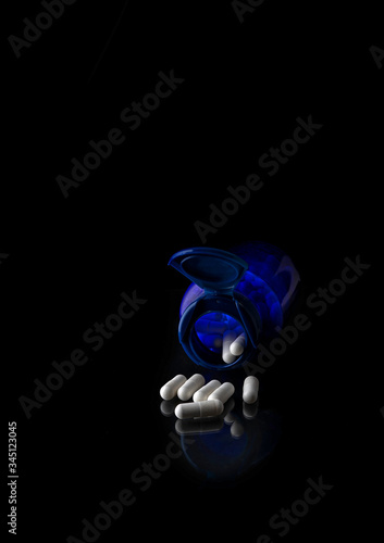 WHITE TABLETS ON A BLACK BACKGROUND