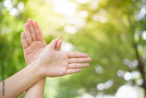 World peace Day , human hand on green background