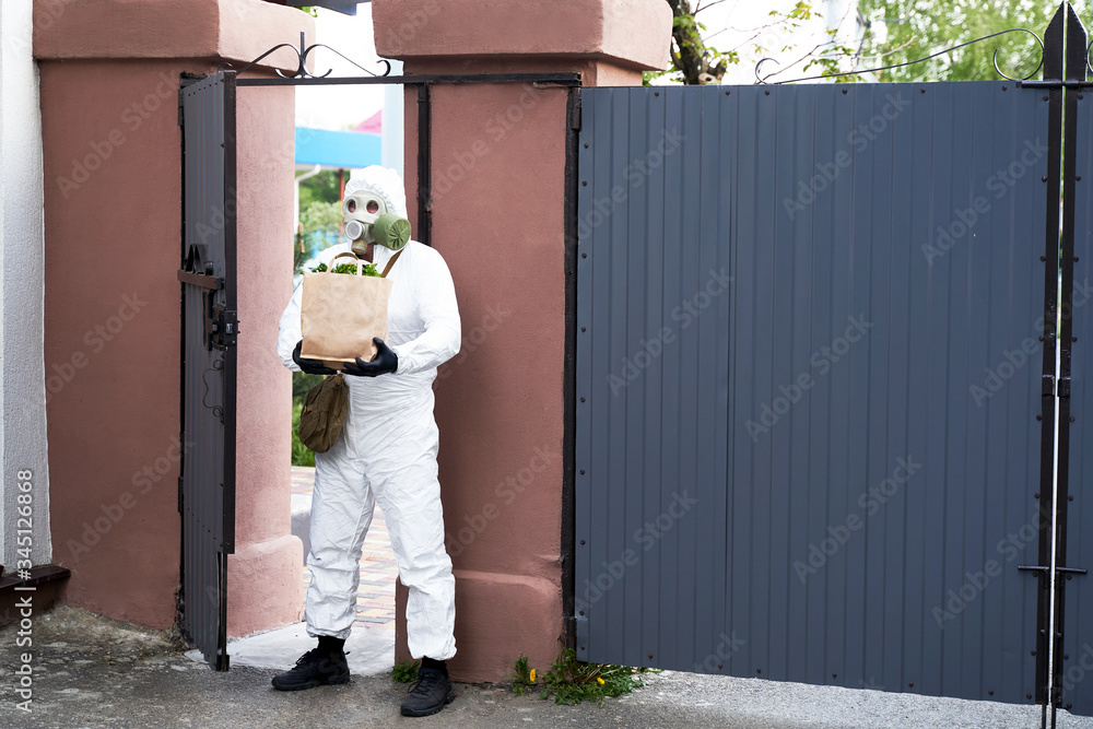 a man in protective clothing and a gas mask brought food a man in protective clothing and a gas mask brought food