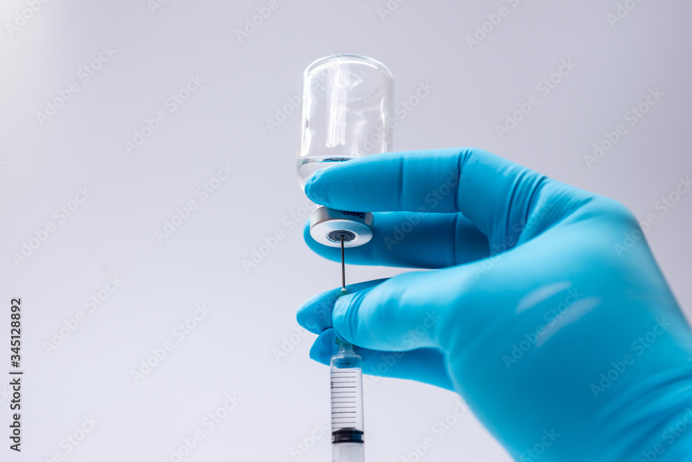 doctor holding a syringe doctor holding a syringe