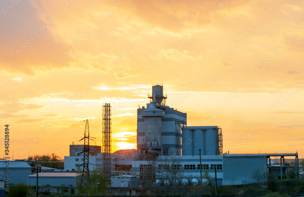 Heavy industry factory building on sunset background
