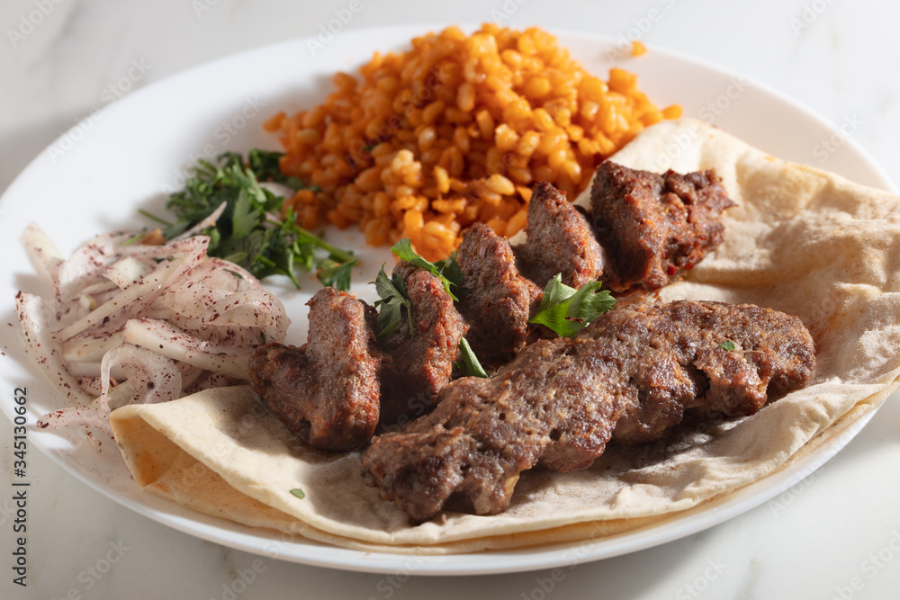 Traditional Adana Kebap with salad Traditional Adana Kebap with salad
