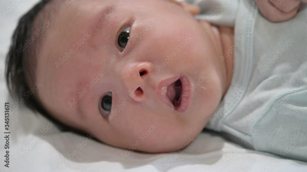 Infant newborn on the white bed,Newborn baby in his baby coat in Hospital after delivery, baby boy lying on a white bed, Family morning at home,Children hygiene. Infant newborn on the white bed,Newborn baby in his baby coat in Hospital after delivery, baby boy lying on a white bed, Family morning at home,Children hygiene.