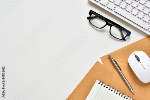 Tableau sur toile Top view white office desk with copy space, Free space for adding needed things or equipment has keyboard, mouse, document, book, pencil and glasses is elements