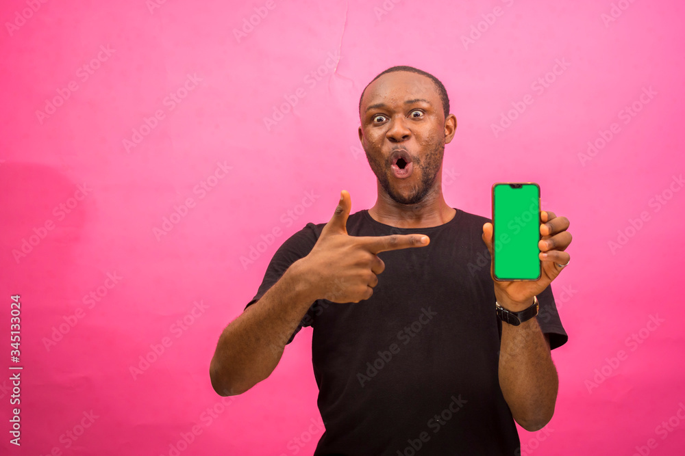 young handsome african man feeling excited about what he saw on his phone young handsome african man feeling excited about what he saw on his phone