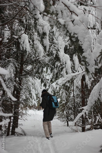 man walks through the winter forest