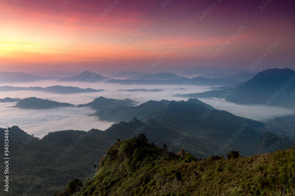 The scenery of Phu Chi Dao that plenty of sea of mist and twilight sky above before sunrise in Chiang Rai province, Thailand.
