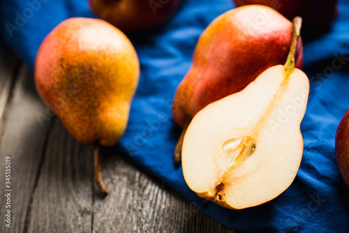 Fresh and ripe sliced pears on the rustic background. Selective focus. Shallow depth of field.