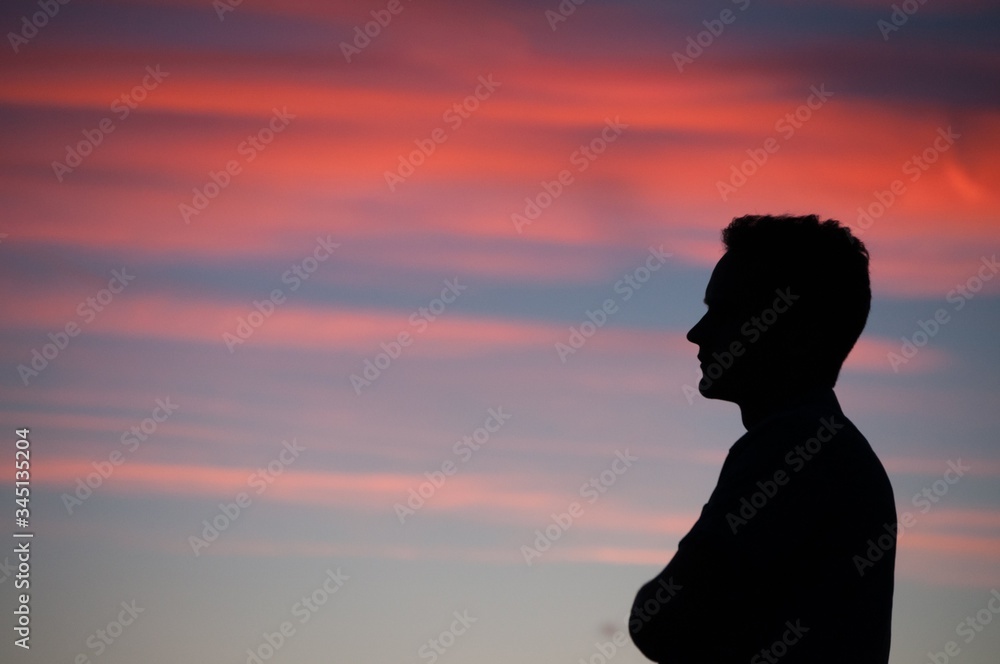 silhouette of man in front of sunset