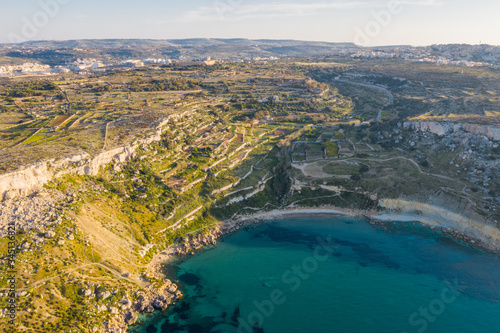 Aerial view of maltese landscape, bay, beach, sunset time. Selmun, Malta 