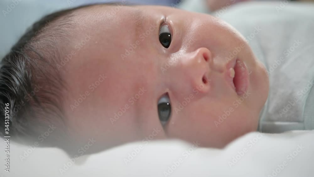 Infant newborn on the white bed,Newborn baby in his baby coat in Hospital after delivery, baby boy lying on a white bed, Family morning at home,Children hygiene. Infant newborn on the white bed,Newborn baby in his baby coat in Hospital after delivery, baby boy lying on a white bed, Family morning at home,Children hygiene.