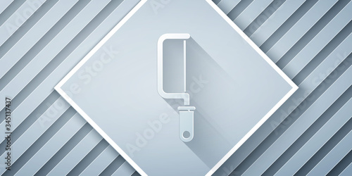 Paper cut Hacksaw icon isolated on grey background. Metal saw for wood and metal. Paper art style. Vector Illustration