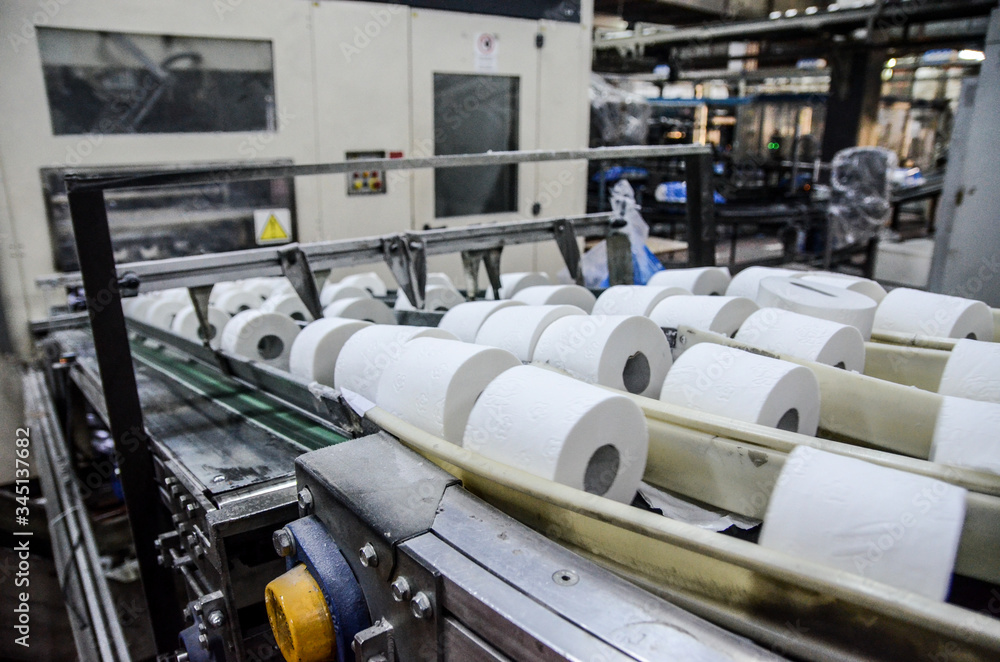 Production of Toilet paper in factory. Toilet paper rolls making