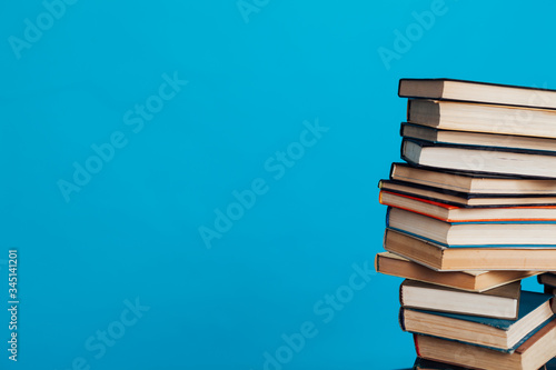 many stacks of educational books for exams at school in the library on a white background