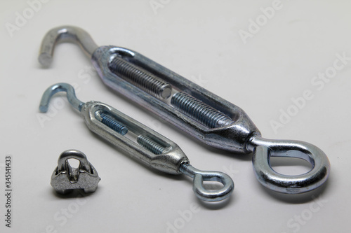 Steel turnbuckle and cable fasteners (wire rope clips) isolated on white background.