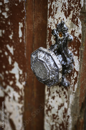 Gray metal handle on old wooden door
