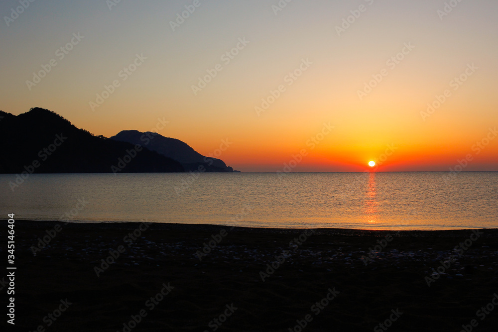 Red sunset on Turkish beach near Mediterranean sea