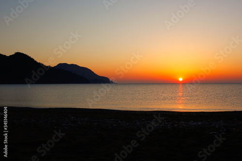 Red sunset on Turkish beach near Mediterranean sea