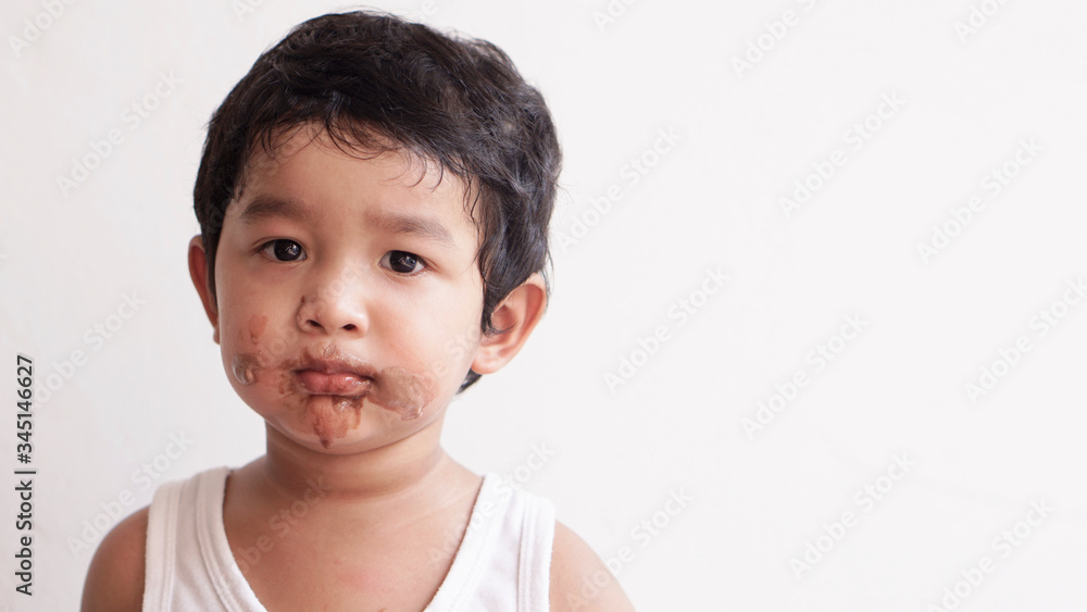 Little boy eating ice cream at home kid has dirty mouth with chocolate summer time concept. Little boy eating ice cream at home kid has dirty mouth with chocolate summer time concept.