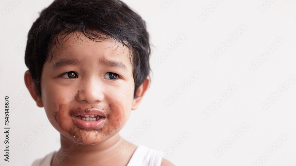 Little boy eating ice cream at home kid has dirty mouth with chocolate summer time concept. Little boy eating ice cream at home kid has dirty mouth with chocolate summer time concept.